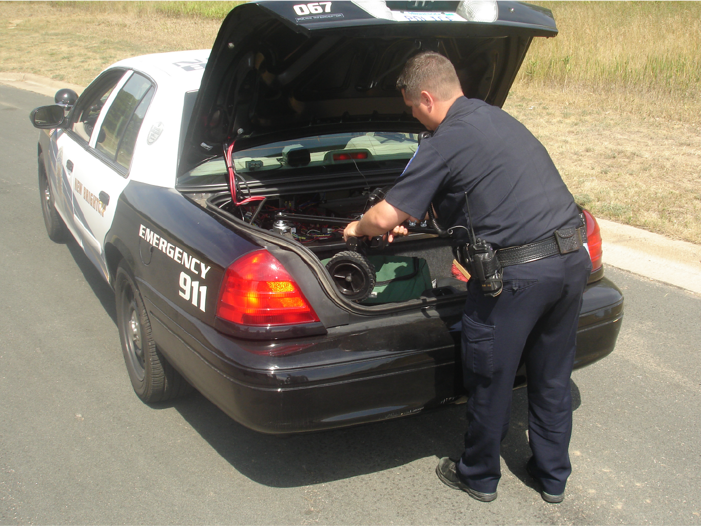 Policeman putting an ATS Targets moving target in the trunk of his car